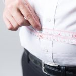 腹囲を測る男性